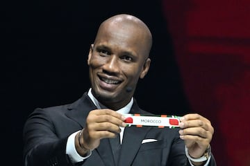 Former Ivorian footballer Didier Drogba shows the paper slip of Morocco during the Africa Cup of Nations (CAN) 2024 official draw 