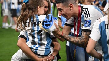 Argentina's midfielder #11 Angel Di Maria celebrates with his wife Jorgelina Cardoso after the awards ceremony after winning the Qatar 2022 World Cup football final match between Argentina and France at Lusail Stadium in Lusail, north of Doha on December 18, 2022. - Argentina won in the penalty shoot-out. (Photo by FRANCK FIFE / AFP)