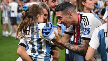 Argentina's midfielder #11 Angel Di Maria celebrates with his wife Jorgelina Cardoso after the awards ceremony after winning the Qatar 2022 World Cup football final match between Argentina and France at Lusail Stadium in Lusail, north of Doha on December 18, 2022. - Argentina won in the penalty shoot-out. (Photo by FRANCK FIFE / AFP)