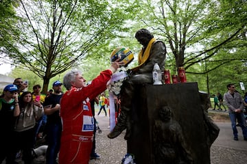 Un aficionado coloca una réplica del casco de Ayrton Senna sobre el monumento dedicado al piloto brasileño para conmemorar el 30 aniversario de su muerte, en el Autodromo Enzo e Dino Ferrari de Ímola, Italia. Senna perdió la vida en un accidente el 1 de mayo de 1994 en el Gran Premio de Fórmula 1 de San Marino.