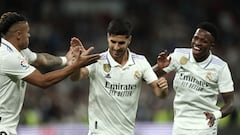 Real Madrid's Spanish midfielder Marco Asensio celebrates with Real Madrid's Brazilian forward Vinicius Junior (R) and Real Madrid's Dominican forward Mariano Diaz (L) scoring his team's first goal during the Spanish league football match between Real Madrid CF and Getafe CF at the Santiago Bernabeu stadium in Madrid on May 13, 2023. (Photo by Thomas COEX / AFP)