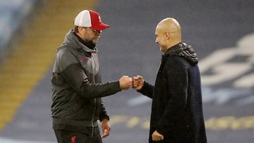 FILE PHOTO: Soccer Football - Premier League - Manchester City v Liverpool - Etihad Stadium, Manchester, Britain - November 8, 2020 Manchester City manager Pep Guardiola and Liverpool manager Juergen Klopp bump fists after the match Pool via REUTERS/Martin Rickett EDITORIAL USE ONLY. No use with unauthorized audio, video, data, fixture lists, club/league logos or 'live' services. Online in-match use limited to 75 images, no video emulation. No use in betting, games or single club /league/player publications.  Please contact your account representative for further details./File Photo