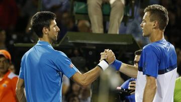 Novak Djokovic and Tomas Berdych shake hands at the net. 