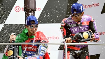 Italian rider Francesco Bagnaia (L) and Ducati Spanish rider Jorge Martin celebrate during the podium ceremony of the Italian MotoGP race at Mugello on June 2, 2024. (Photo by Marco BERTORELLO / AFP)