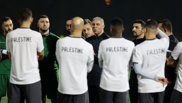 Palestine coach Makram Daboub speaks to his players during training REUTERS/Thaier Al-Sudani