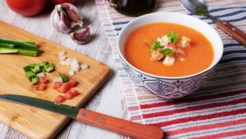 Gazpacho, cold soup typical of Andalusia based on tomato, garlic, pepper and onion. On a white wooden background.