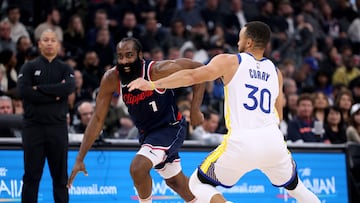 James Harden #1 of the LA Clippers drives to the basket on Stephen Curry #30 of the Golden State Warriors in front of Tyronn Lue during the first half at Intuit Dome on November 18, 2024 in Inglewood, California.