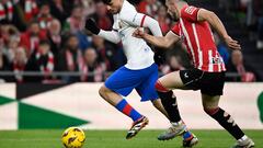 Barcelona's Spanish midfielder #08 Pedri (L) is challenged by Athletic Bilbao's Spanish defender #04 Aitor Paredes during the Spanish league football match between Athletic Club Bilbao and FC Barcelona at the San Mames stadium in Bilbao on March 3, 2024. (Photo by ANDER GILLENEA / AFP)