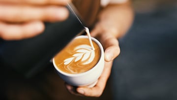 Coffee Art In Cup. Closeup Of Barista Hands Making Latte Art Picture With Milk On Coffee. High Resolution