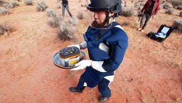 South Australia (Australia), 05/12/2020.- A handout photo made available by the Japan Aerospace Exploration Agency (JAXA) shows a staff member carrying the capsule, which contains samples from an asteroid, after it landed in the state of South Australia, 