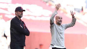 Manchester City Manager / Head Coach Pep Guardiola reacts as Liverpool Head Coach / Manager Jurgen Klopp looks on during The Emirates FA Cup Semi-Final match between Manchester City and Liverpool