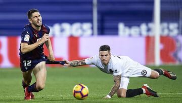 EIBAR, SPAIN - DECEMBER 15: Santiago Mina of Valencia CF duels for the ball with Paulo Oliveira of SD Eibar during the La Liga match between SD Eibar and Valencia CF at Ipurua Municipal Stadium on December 15, 2018 in Eibar, Spain. (Photo by Juan Manuel