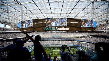 INGLEWOOD, CALIFORNIA - SEPTEMBER 10: Fans slap hands during a game between the Miami Dolphins and the Los Angeles Chargers at SoFi Stadium on September 10, 2023 in Inglewood, California.   Ronald Martinez/Getty Images/AFP (Photo by RONALD MARTINEZ / GETTY IMAGES NORTH AMERICA / Getty Images via AFP)