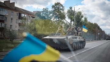 Ukrainian service members ride on an armoured fighting vehicle in the town of Kupiansk, recently liberated by the Armed Forces, amid Russia's attack on Ukraine, in Kharkiv region.