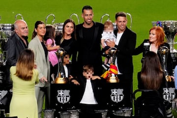 Busquets posa con su familia ante sus títulos con el Barcelona.