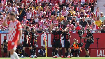 Barcelona's Spanish forward #19 Lamine Yamal celebrates scoring his team's first goal with teammates during the Spanish league football match between Girona FC and FC Barcelona at the Montilivi stadium in Girona on September 15, 2024. (Photo by LLUIS GENE / AFP)