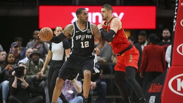 Mar 6, 2019; Atlanta, GA, USA; San Antonio Spurs center LaMarcus Aldridge (12) is defended by Atlanta Hawks center Alex Len (25) in the second quarter at State Farm Arena. Mandatory Credit: Brett Davis-USA TODAY Sports