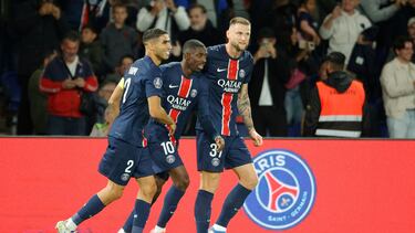Paris Saint-Germain's French forward #10 Ousmane Dembele (C) celebrates scoring PSG's first goal with Paris Saint-Germain's Slovak defender #37 Milan Skriniar (R) and Paris Saint-Germain's Moroccan defender #02 Achraf Hakimi (L) during the French L1 football match between Paris Saint-Germain (PSG) and Stade Brestois 29 (Brest) at The Parc des Princes Stadium, in Paris, on September 14, 2024. (Photo by GEOFFROY VAN DER HASSELT / AFP)