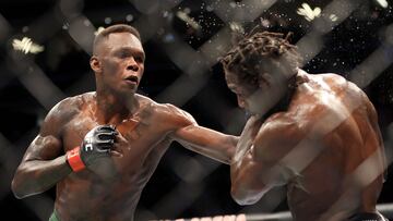 LAS VEGAS, NEVADA - JULY 02: Israel Adesanya (L) of Nigeria punches Jared Cannonier in their middleweight title bout during UFC 276 at T-Mobile Arena on July 02, 2022 in Las Vegas, Nevada.   Carmen Mandato/Getty Images/AFP
== FOR NEWSPAPERS, INTERNET, TELCOS & TELEVISION USE ONLY ==