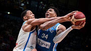 Greece�s Giannis Antentokoumbo (R) is marked by Angel Nunez of the Dominican Republic during the 2024 FIBA Olympic Qualifying Tournament basketball match between Greece and the Dominican Republic at the Peace and Friendship Stadium in Athens on July 3, 2024. (Photo by Aris MESSINIS / AFP)