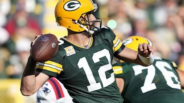 GREEN BAY, WISCONSIN - OCTOBER 02: Aaron Rodgers #12 of the Green Bay Packers attempts a pass during the second quarter against the New England Patriots at Lambeau Field on October 02, 2022 in Green Bay, Wisconsin.   Patrick McDermott/Getty Images/AFP