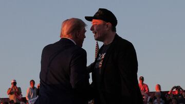 FILE PHOTO: Tesla CEO and X owner Elon Musk stands with Republican presidential candidate former U.S. president Donald Trump during a campaign rally in Butler, Pennsylvania, U.S., October 5, 2024. REUTERS/Brian Snyder/File Photo