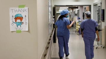 Healthcare workers walk through the hallway as staff care for patients suffering from coronavirus disease (COVID-19) at Humber River Hospital's Intensive Care Unit, in Toronto, Ontario, Canada, on April 28, 2021. (Photo by Cole Burston / AFP)