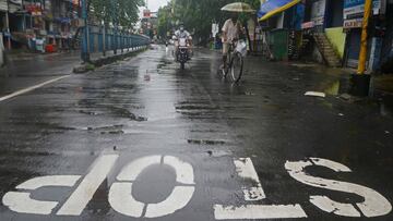 Motorists ride along the deserted road after a new lockdown was imposed as a preventive measure against the spread of the COVID-19 coronavirus, in Siliguri on July 20, 2020. - India on July 17 hit a million coronavirus cases, the third-highest total in th