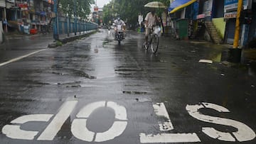 Motorists ride along the deserted road after a new lockdown was imposed as a preventive measure against the spread of the COVID-19 coronavirus, in Siliguri on July 20, 2020. - India on July 17 hit a million coronavirus cases, the third-highest total in th