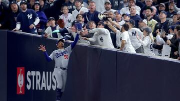 FILE PHOTO: Oct 29, 2024; New York, New York, USA; Los Angeles Dodgers shortstop Mookie Betts (50) makes a catch in foul territory as a New York Yankees fan interferes during the first inning in game four of the 2024 MLB World Series at Yankee Stadium. Mandatory Credit: Brad Penner-Imagn Images/File Photo