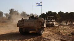 Israeli soldiers gesture while riding in an armoured personnel carrier (APC), after returning from the Gaza Strip, amid the ongoing conflict between Israel and Hamas, near the Israel-Gaza border, in Israel, June 5, 2024. REUTERS/Amir Cohen