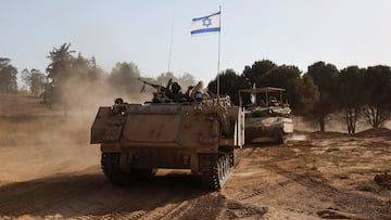 Israeli soldiers gesture while riding in an armoured personnel carrier (APC), after returning from the Gaza Strip, amid the ongoing conflict between Israel and Hamas, near the Israel-Gaza border, in Israel, June 5, 2024. REUTERS/Amir Cohen