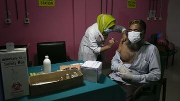 DHAKA, BANGLADESH - JULY 6: A man receives a Pfizer COVID-19 vaccine on July 6, 2021 in Dhaka, Bangladesh. Bangladesh enacted a nationwide lockdown on July 1st in an effort to contain a third wave of coronavirus as cases have surged, fueled by the Delta v