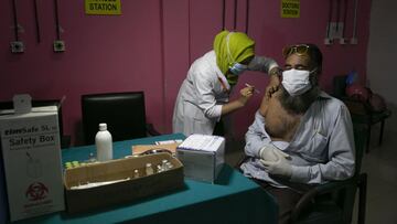 DHAKA, BANGLADESH - JULY 6: A man receives a Pfizer COVID-19 vaccine on July 6, 2021 in Dhaka, Bangladesh. Bangladesh enacted a nationwide lockdown on July 1st in an effort to contain a third wave of coronavirus as cases have surged, fueled by the Delta variant first detected in neighboring India. (Photo by Allison Joyce/Getty Images)