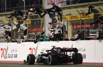 Lewis Hamilton celebra la victoria de carrera con su equipo. 