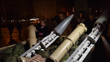 LVIV, UKRAINE - DECEMBER 31: People look at the wreckage of Russian missiles displayed in the square near the Christmas tree on New Year's Eve in Lviv, December 31, 2022. Due to the war and curfew, no New Year's events took place in the city. (Photo by Pavlo Palamarchuk/Anadolu Agency via Getty Images)