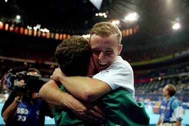 Este gimnasta australiano que ahora tiene 44 años llegó a ser campeón del mundo y plata olímpica en Sidney en la prueba de trampolín. También llegó a marcar un récord olímpico en esta disciplina. Desde 2005, que hizo pública su homosexualidad, se convirtió en un icono de la comunidad gay. Compitió hasta 2007 y luego llegó a formar parte del Circo del Sol. En 2012, en una carta publicada en un medio, anunció que era portador del VIH. Actualmente ha realizado labores de entrenador. 