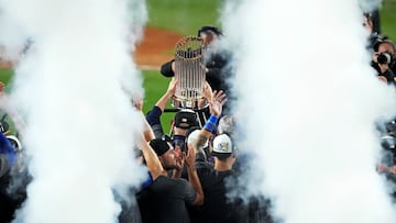 Oct 31, 2024; New York, New York, USA; The Los Angeles Dodgers celebrates with the Commissioner's Trophy after beating the New York Yankees in game four to win the 2024 MLB World Series at Yankee Stadium. Mandatory Credit: Robert Deutsch-Imagn Images