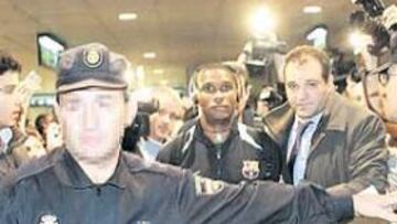 <b>PROTAGONISTA. </b>Etoo, que escucha música rodeado de policías, a la llegada del Barcelona al aeropuerto de Barajas.