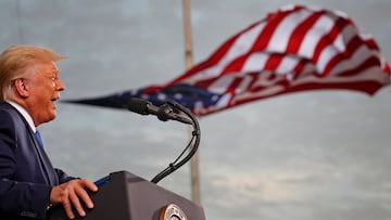 U.S. President Donald Trump speaks, with a flag behind him, during a campaign rally at Cecil Airport in Jacksonville, Florida, U.S., September 24, 2020. REUTERS/Tom Brenner/File Photo TPX IMAGES OF THE DAY SEARCH "POY USA ELECTION"