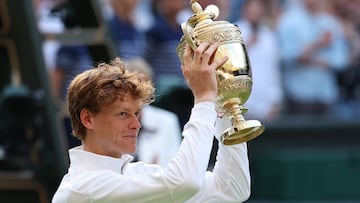 Tennis - Wimbledon - All England Lawn Tennis and Croquet Club, London, Britain - July 13, 2025 Italy's Jannik Sinner celebrates with the trophy after winning the men's final against Spain's Carlos Alcaraz REUTERS/Toby Melville