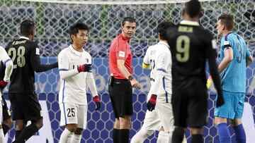 Atletico Nacional players remonstrate with Referee Viktor Kassai