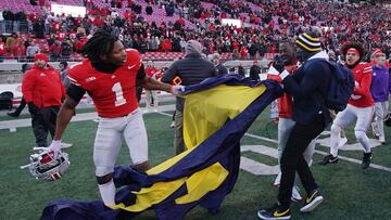 COLUMBUS, OHIO - NOVEMBER 30: Davison Igbinosun #1 of the Ohio State Buckeyes grabs a Michigan flag following his team's defeat against the Michigan Wolverines at Ohio Stadium on November 30, 2024 in Columbus, Ohio. Jason Mowry/Getty Images/AFP (Photo by Jason Mowry / GETTY IMAGES NORTH AMERICA / Getty Images via AFP)
