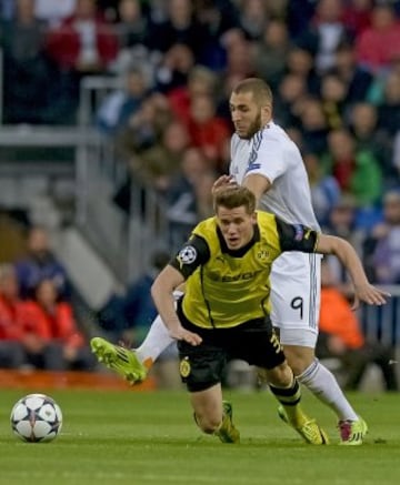 Erik Durm y Karim Benzema.