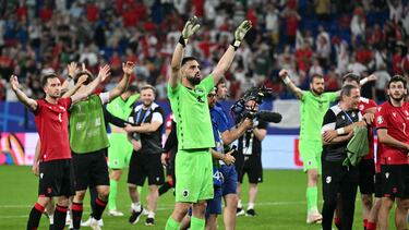 Georgia's goalkeeper #25 Giorgi Mamardashvili and Georgia's players cheer their supporters after they won the UEFA Euro 2024 Group F football match between Georgia and Portugal at the Arena AufSchalke in Gelsenkirchen on June 26, 2024. (Photo by PATRICIA DE MELO MOREIRA / AFP)