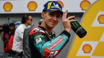 Petronas Yamaha SRTx92s French rider Fabio Quartararo celebrates his pole position after the MotoGP qualifying session of the Malaysian Grand Prix motorcycle race at the Sepang International Circuit in Sepang on November 2, 2019. (Photo by Mohd RASFAN / AFP)