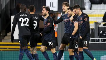 13 March 2021, United Kingdom, London: Manchester City&#039;s John Stones (C) celebrates scoring his side&#039;s first goal with team-mates during the English Premier League soccer match between Fulham and Manchester City at Craven Cottage. Photo: Catheri