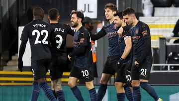 13 March 2021, United Kingdom, London: Manchester City's John Stones (C) celebrates scoring his side's first goal with team-mates during the English Premier League soccer match between Fulham and Manchester City at Craven Cottage. Photo: Catheri