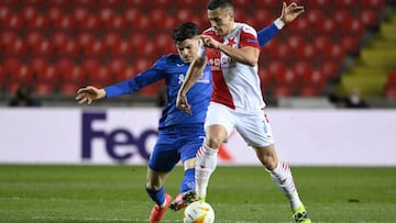 11 March 2021, Czech Republic, Prague: Prague&#039;s Tomas Holes (R) and Rangers&#039; Ianis Hagi battle for the ball during the UEFA Europa League round of sixteen, first leg soccer match between SK Slavia Prague and Rangers FC at Sinobo Stadium. Photo: 