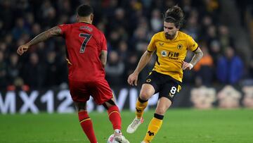 10 March 2022, United Kingdom, Wolverhampton: Watford&#039;s Joshua King (L) and Wolverhampton Wanderers&#039; Ruben Neves battle for the ball during the English Premier League soccer match between Wolverhampton Wanderers and Watford at Molineux Stadium. 